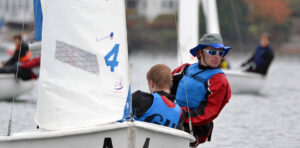 2 young guys sailing a boat